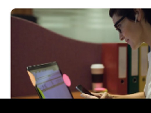 Marketer reviewing a website on a laptop